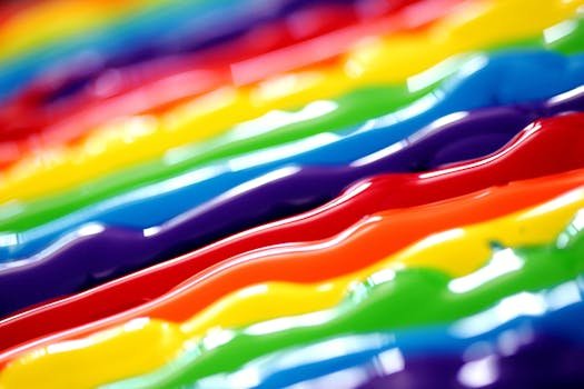 A vibrant abstract background featuring flowing rainbow colors in a creative artistic style.